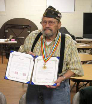 Gill Loomis displays the Korean Ambassador for Peace Medal he received, along with the citation document, at the November 2 event at Edmonds Community College