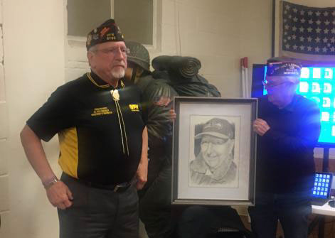 Mike Reagan presented a portrait of Harlow “Bud” Hart to Craig Dougherty.