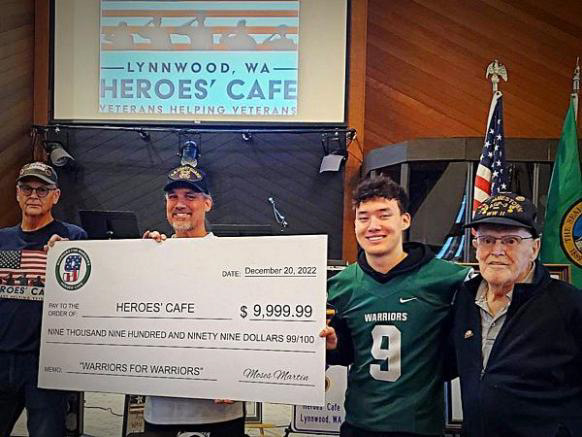 “Team Mojo” Presents Check to Heroes’ Cafe 